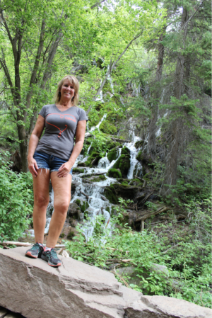 uterine fibroids | CU Rocky Mountain OB-GYN | patient Lisa poses by waterfall